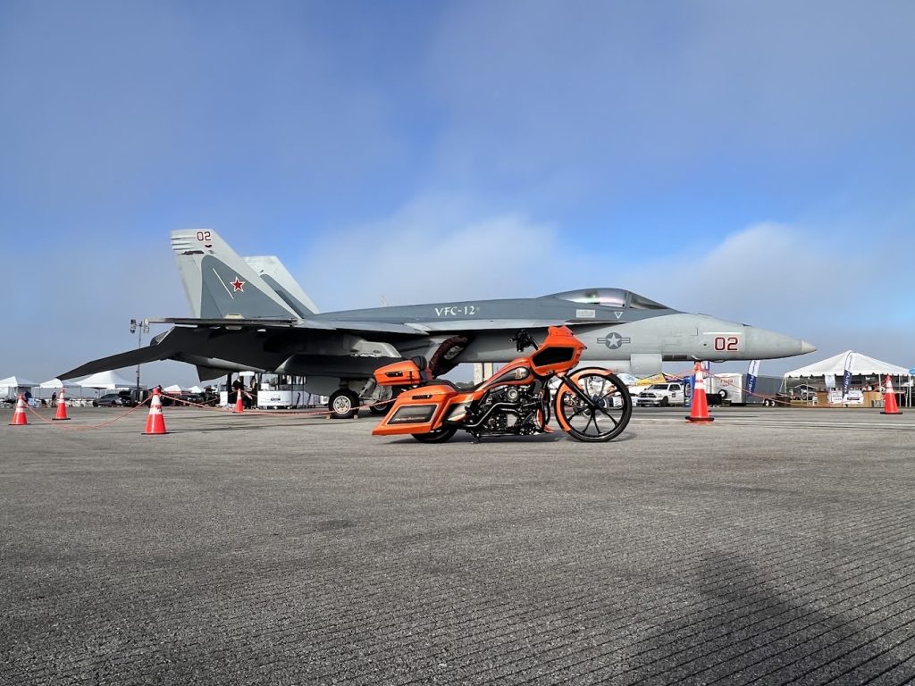 Custom motorcycle photographed in front of an airplane